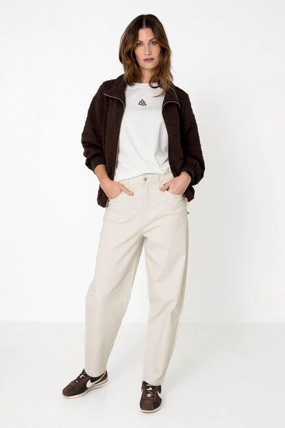 offwhite barreljeans lagos in combinatie met wit t-shirt en bruin jasje